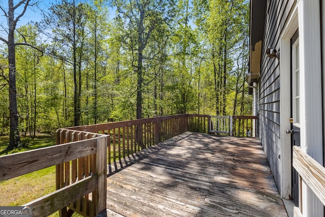 wooden deck with a view of trees