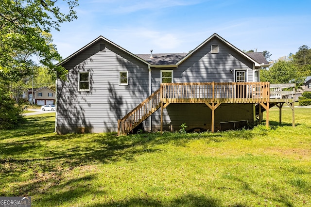 back of property with a wooden deck, a yard, and stairs