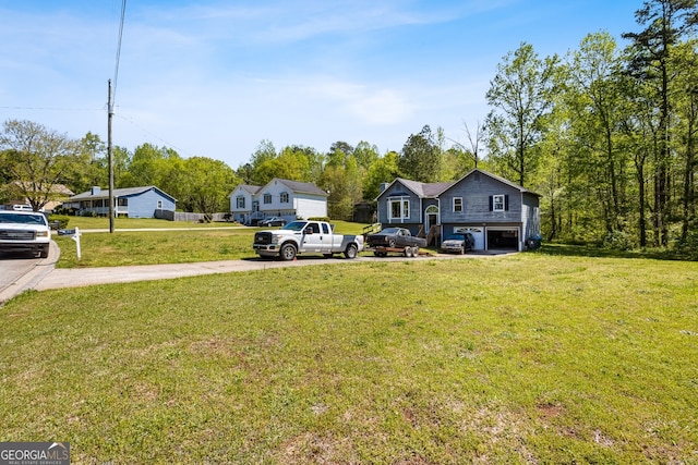 view of yard with driveway and an attached garage