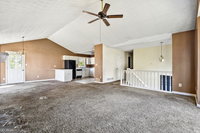 unfurnished living room featuring a textured ceiling, a ceiling fan, vaulted ceiling, and baseboards
