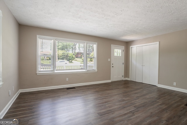 2041 W Flat Shoals Ter, Decatur, GA 30034 - entryway with a textured ceiling, visible vents, baseboards, and dark wood finished floors