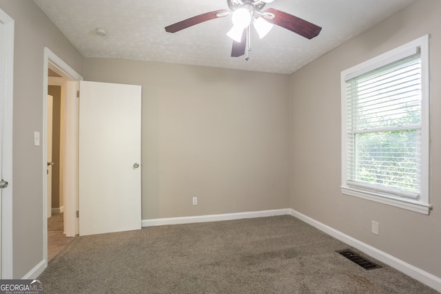 2041 W Flat Shoals Ter, Decatur, GA 30034 - carpeted empty room featuring a wealth of natural light, visible vents, a ceiling fan, and baseboards