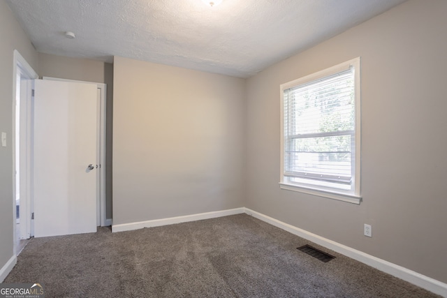 2041 W Flat Shoals Ter, Decatur, GA 30034 - carpeted spare room with baseboards, visible vents, and a textured ceiling