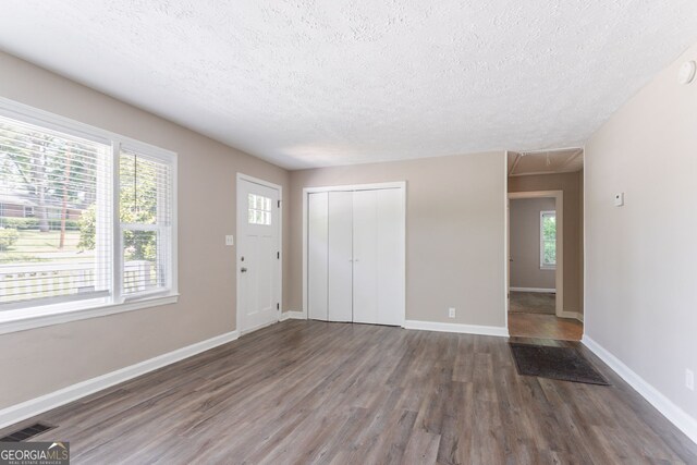 2041 W Flat Shoals Ter, Decatur, GA 30034 - foyer with a textured ceiling, visible vents, wood finished floors, and baseboards