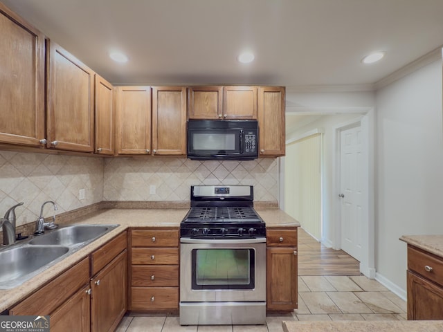 3301 Henderson Mill Rd Unit D3, Atlanta, GA 30341 - kitchen with black microwave, a sink, stainless steel gas stove, light countertops, and decorative backsplash