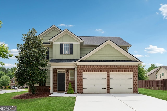 view of front facade featuring driveway, board and batten siding, fence, brick siding, and a front lawn