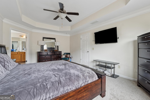 carpeted bedroom featuring ornamental molding, a ceiling fan, baseboards, and a tray ceiling