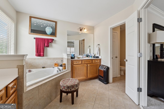bathroom featuring tile patterned floors, plenty of natural light, a bath, and vanity