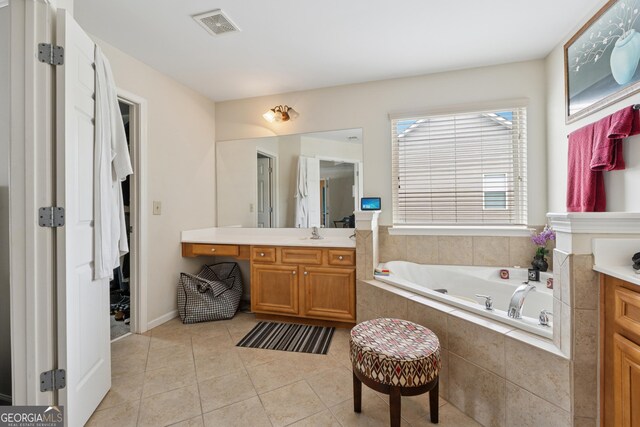 bathroom featuring visible vents, a garden tub, tile patterned flooring, and vanity