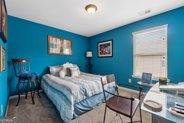 carpeted bedroom featuring baseboards and visible vents