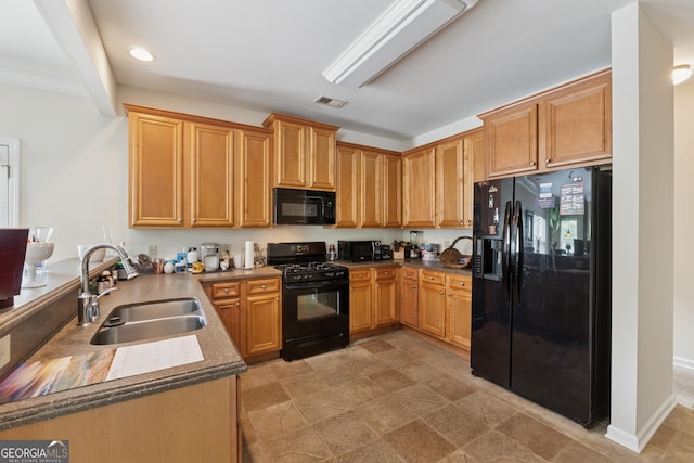 kitchen featuring recessed lighting, black appliances, a sink, visible vents, and a peninsula