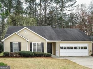 ranch-style home featuring an attached garage, driveway, and a front yard