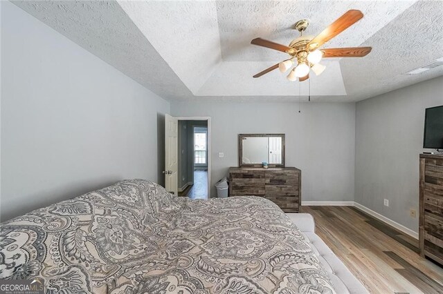 2889 Estuary Dr, Acworth, GA 30101 - bedroom with wood finished floors, a ceiling fan, a textured ceiling, visible vents, and baseboards