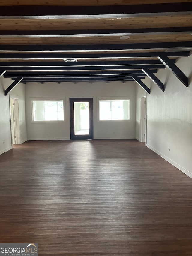 854 Clearwater Rd, Sharpsburg, GA 30277 - unfurnished living room featuring wood finished floors, baseboards, plenty of natural light, and beamed ceiling