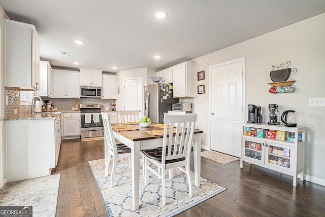 3399 In Bloom Way, Auburn, GA 30011 - dining area with dark wood-style floors, baseboards, and recessed lighting
