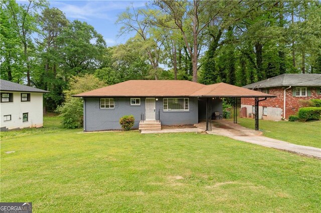2823 Connally Dr SW, Atlanta, GA 30311 - view of front facade featuring driveway, an attached carport, a front yard, and view of scattered trees