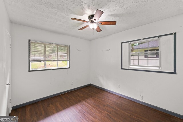 2823 Connally Dr SW, Atlanta, GA 30311 - empty room featuring dark wood finished floors, ceiling fan, baseboards, and a textured ceiling