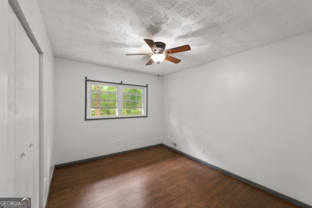 2823 Connally Dr SW, Atlanta, GA 30311 - unfurnished bedroom featuring a closet, dark wood finished floors, baseboards, a textured ceiling, and a ceiling fan