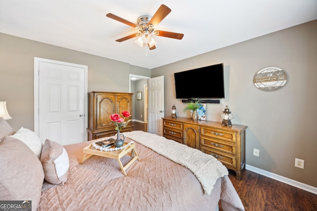 bedroom with dark wood-style floors, baseboards, and a ceiling fan