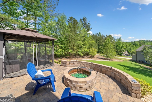 view of patio with a gazebo and an outdoor fire pit