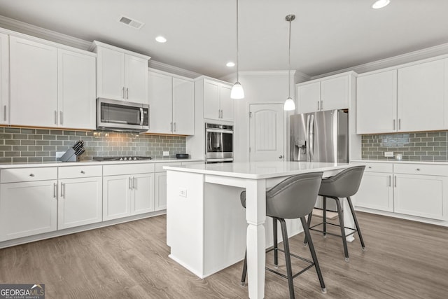 1606 Chancery Ln, Lithia Springs, GA 30122 - kitchen with appliances with stainless steel finishes, backsplash, light countertops, white cabinetry, and recessed lighting