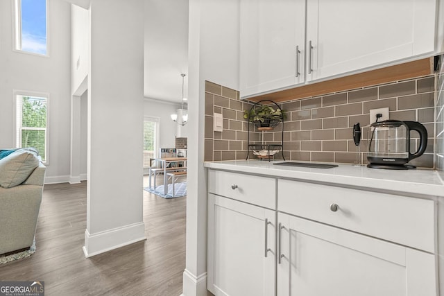 1606 Chancery Ln, Lithia Springs, GA 30122 - kitchen featuring baseboards, light countertops, white cabinetry, and backsplash