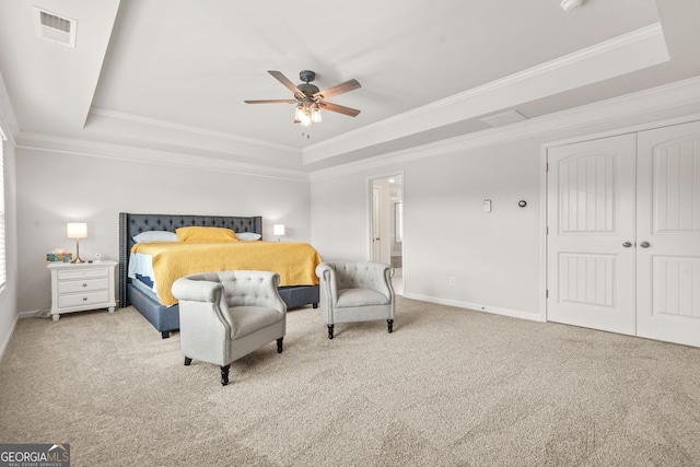 1606 Chancery Ln, Lithia Springs, GA 30122 - carpeted bedroom featuring a raised ceiling, ornamental molding, baseboards, a closet, and a ceiling fan