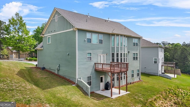 1606 Chancery Ln, Lithia Springs, GA 30122 - rear view of property with board and batten siding, a yard, a patio area, and a shingled roof