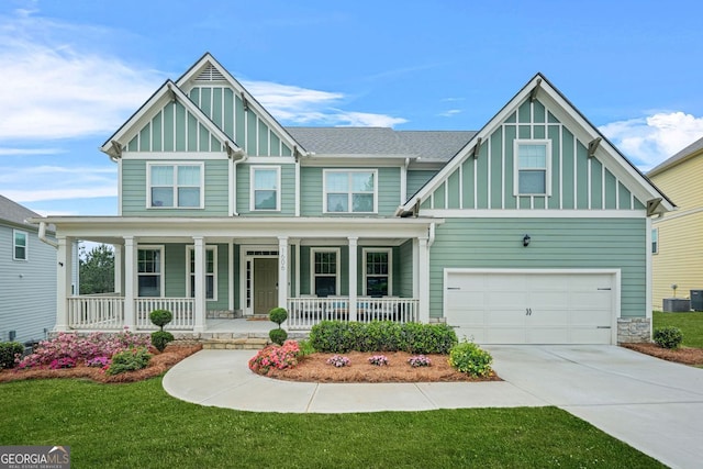 1606 Chancery Ln, Lithia Springs, GA 30122 - craftsman house with board and batten siding, a porch, central AC unit, and a garage