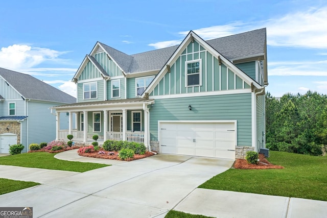 1606 Chancery Ln, Lithia Springs, GA 30122 - craftsman house featuring a porch, board and batten siding, concrete driveway, a front yard, and an attached garage