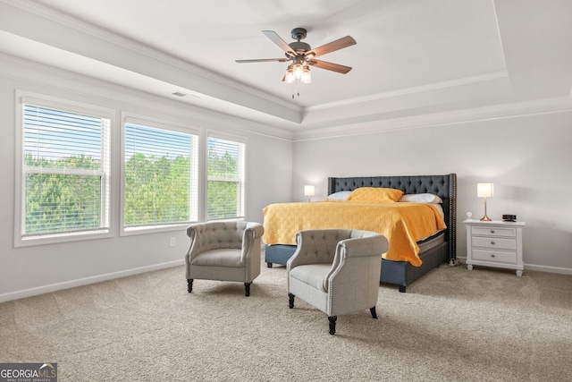 1606 Chancery Ln, Lithia Springs, GA 30122 - carpeted bedroom featuring a raised ceiling, baseboards, crown molding, and a ceiling fan
