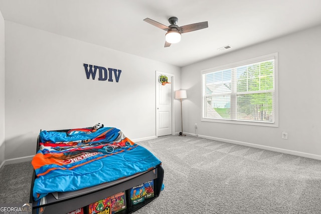 1606 Chancery Ln, Lithia Springs, GA 30122 - carpeted bedroom with baseboards and a ceiling fan
