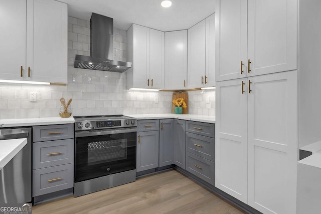 3182 Wakefield Dr, Decatur, GA 30034 - kitchen featuring gray cabinets, stainless steel appliances, wall chimney exhaust hood, and light countertops