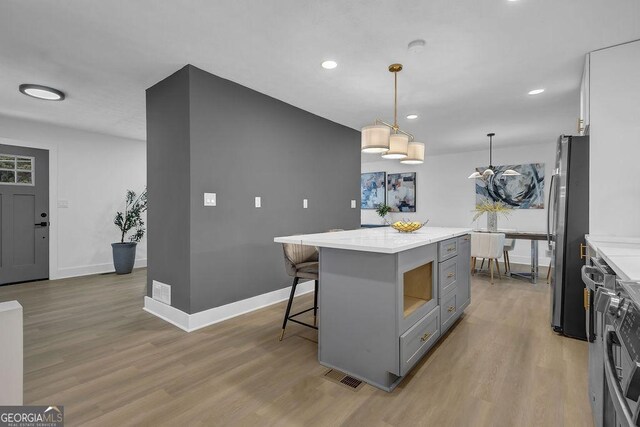 3182 Wakefield Dr, Decatur, GA 30034 - kitchen with visible vents, gray cabinetry, light wood finished floors, and freestanding refrigerator