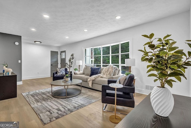 3182 Wakefield Dr, Decatur, GA 30034 - living area featuring recessed lighting, a textured ceiling, wood finished floors, and baseboards