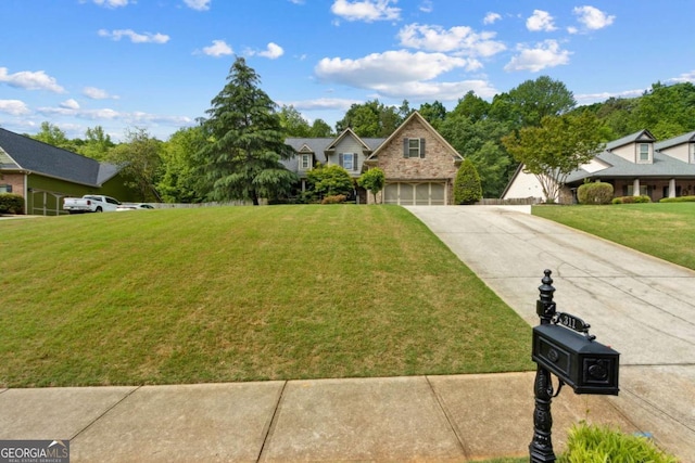 traditional-style house with a garage, a front lawn, driveway, and stone siding
