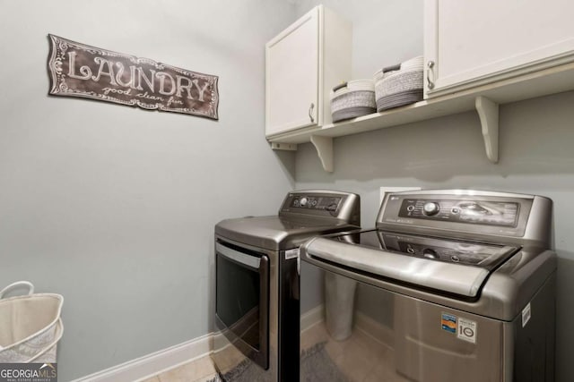laundry room with separate washer and dryer, cabinet space, and baseboards