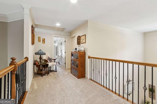 corridor featuring recessed lighting, attic access, an upstairs landing, carpet flooring, and crown molding