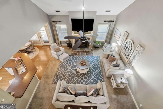 living room featuring baseboards, visible vents, and carpet flooring