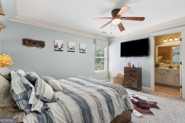 bedroom featuring ornamental molding, ceiling fan, light carpet, and ensuite bathroom