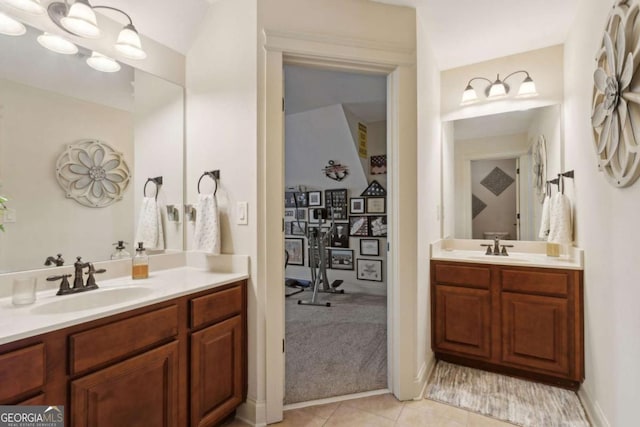bathroom featuring two vanities, a sink, tile patterned floors, and baseboards