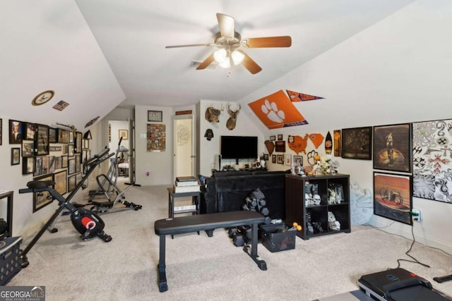 exercise room featuring lofted ceiling, ceiling fan, and carpet floors