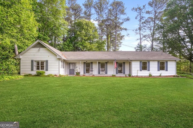 ranch-style home featuring a porch and a front yard