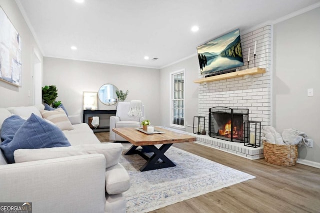 living area with recessed lighting, ornamental molding, wood finished floors, and a fireplace