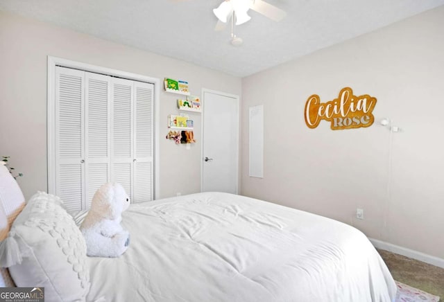 carpeted bedroom with baseboards, ceiling fan, and a closet