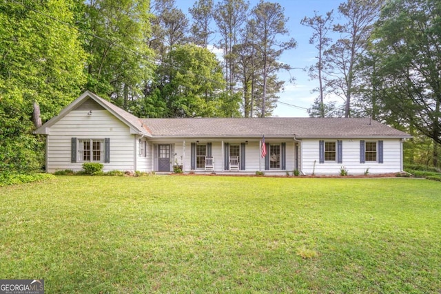 ranch-style home with covered porch and a front lawn
