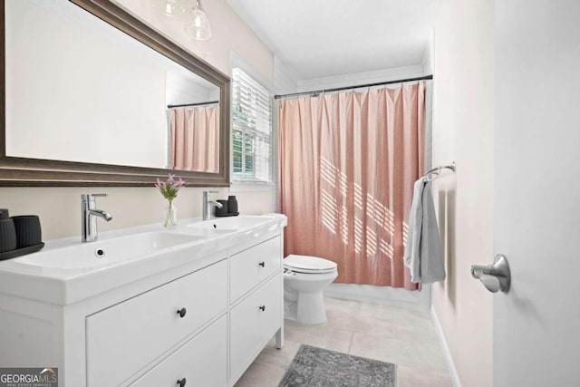 full bathroom with a sink, tile patterned flooring, toilet, and double vanity