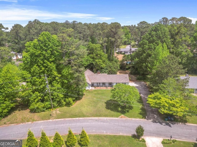 bird's eye view with a wooded view
