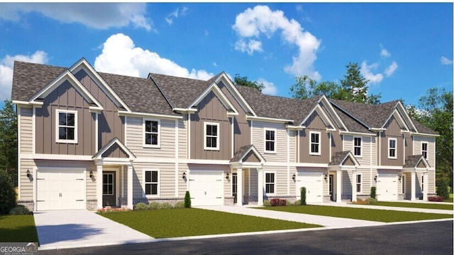 view of property featuring a garage, driveway, and a front lawn