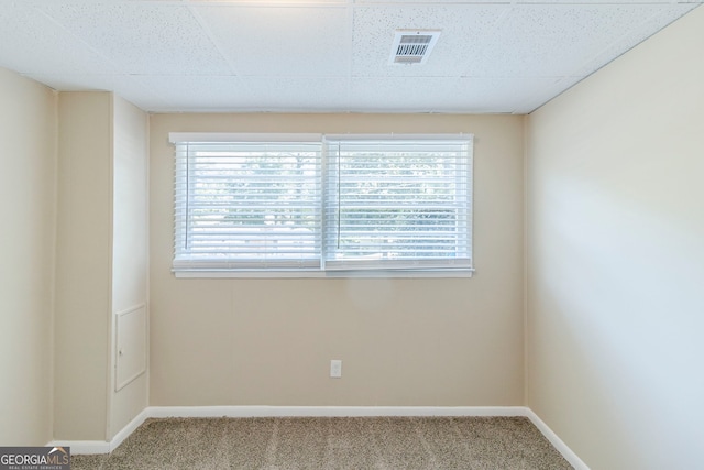 spare room featuring visible vents, carpet, plenty of natural light, and baseboards